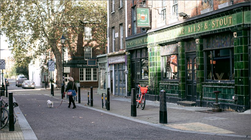 Green pub shopfront in London. Cow & Co estate agency in London